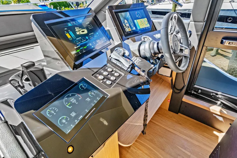 Joan's Rondevous Yacht Photos Pics Cockpit of 2025 Absolute 52 FLY yacht with advanced digital controls and steering wheel.