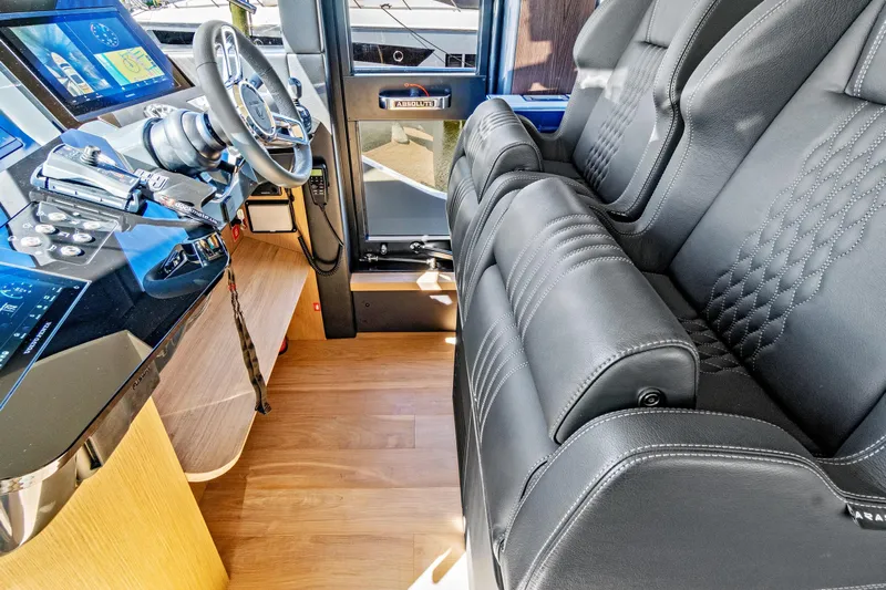 Joan's Rondevous Yacht Photos Pics Luxurious interior of 2025 Absolute 52 FLY yacht with leather seating and advanced controls.