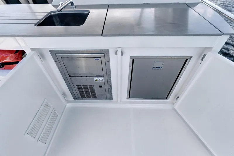 Joan's Rondevous Yacht Photos Pics Outdoor kitchen area on 2025 Absolute 52 FLY yacht with sink and storage.