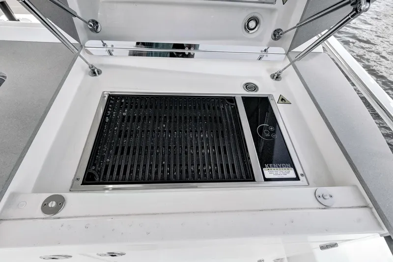 Joan's Rondevous Yacht Photos Pics Outdoor grill on 2025 Absolute 52 FLY yacht, featuring Kenyon electric cooktop.