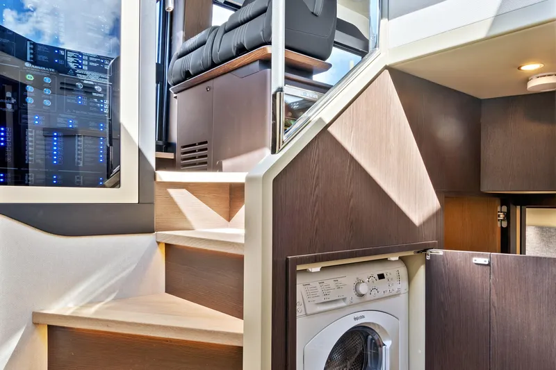 Joan's Rondevous Yacht Photos Pics Interior of 2025 Absolute 52 FLY yacht with stairs and built-in washing machine.
