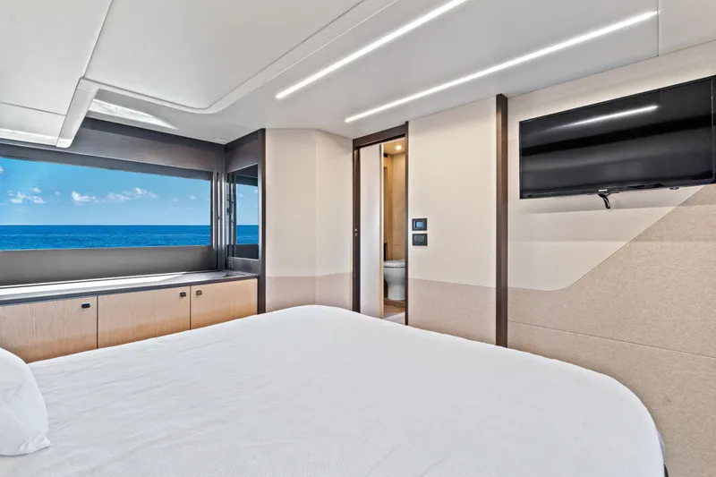 Joan's Rondevous Yacht Photos Pics Luxurious bedroom interior of 2025 Absolute 52 FLY yacht with ocean view.