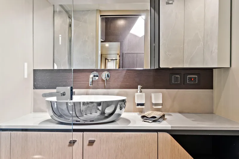 Joan's Rondevous Yacht Photos Pics Luxurious bathroom interior of 2025 Absolute 52 FLY yacht with modern sink and fixtures.