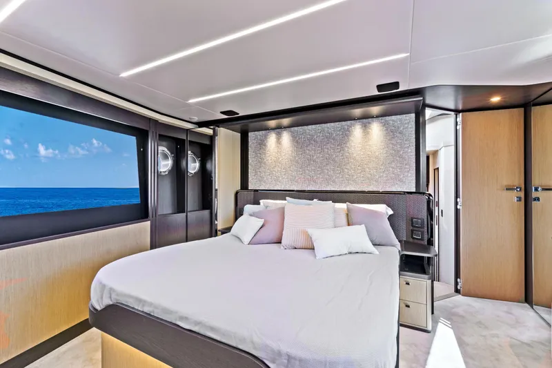 Joan's Rondevous Yacht Photos Pics Luxurious bedroom interior of 2025 Absolute 52 FLY yacht with ocean view.