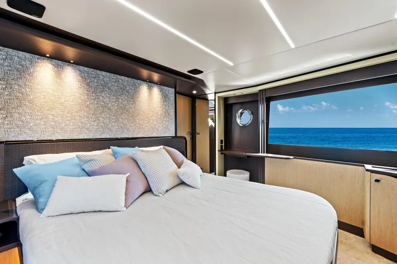Joan's Rondevous Yacht Photos Pics Luxurious bedroom interior of 2025 Absolute 52 FLY yacht with ocean view.