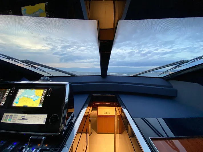  Yacht Photos Pics Cockpit view of 2020 Riva 66' Ribelle yacht with navigation screens and ocean horizon.