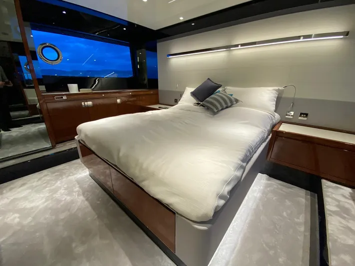  Yacht Photos Pics Luxurious bedroom interior of 2020 Riva 66' Ribelle yacht with modern design and ambient lighting.