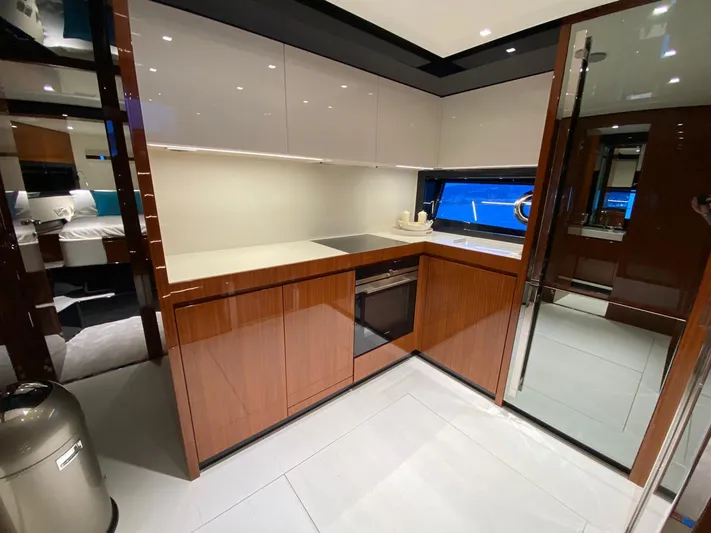  Yacht Photos Pics Modern kitchen interior on 2020 Riva 66' Ribelle yacht, featuring sleek cabinetry and appliances.