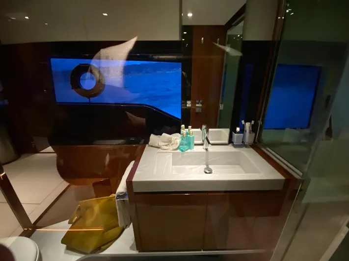  Yacht Photos Pics Luxurious bathroom interior on a 2020 Riva 66' Ribelle yacht, featuring modern sink and window.