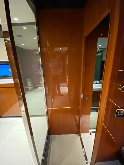  Yacht Photos Pics Interior of 2020 Riva 66' Ribelle yacht with sleek wood paneling and modern design.