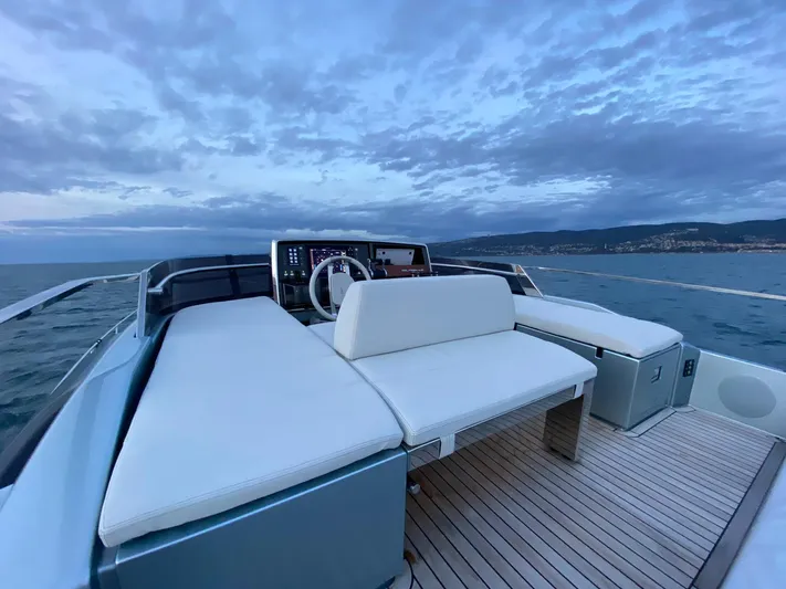  Yacht Photos Pics Luxurious 2020 Riva 66' Ribelle yacht deck with elegant seating and ocean view.