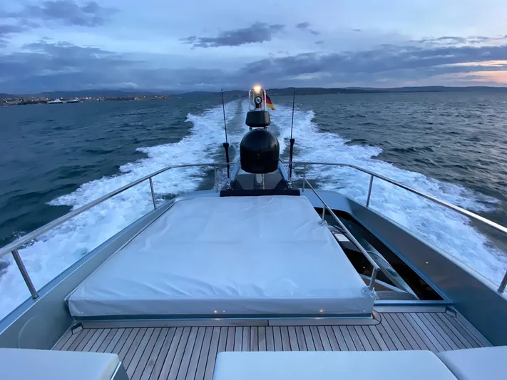  Yacht Photos Pics 2020 Riva 66' Ribelle yacht cruising at sunset, with wake trailing behind.