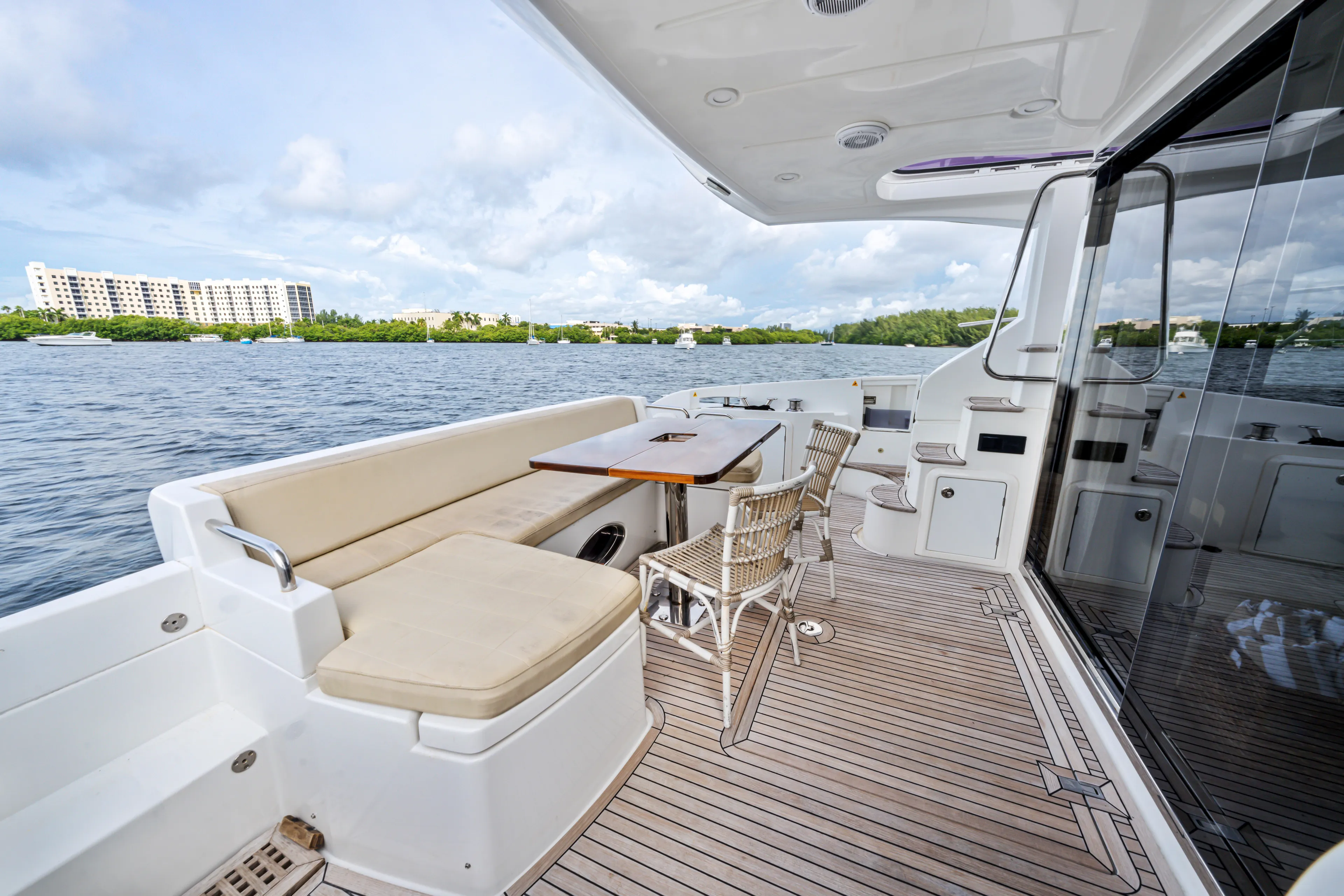  Yacht Photos Pics Azimut 54 Flybridge 2016 yacht deck with seating and table, overlooking serene waters.