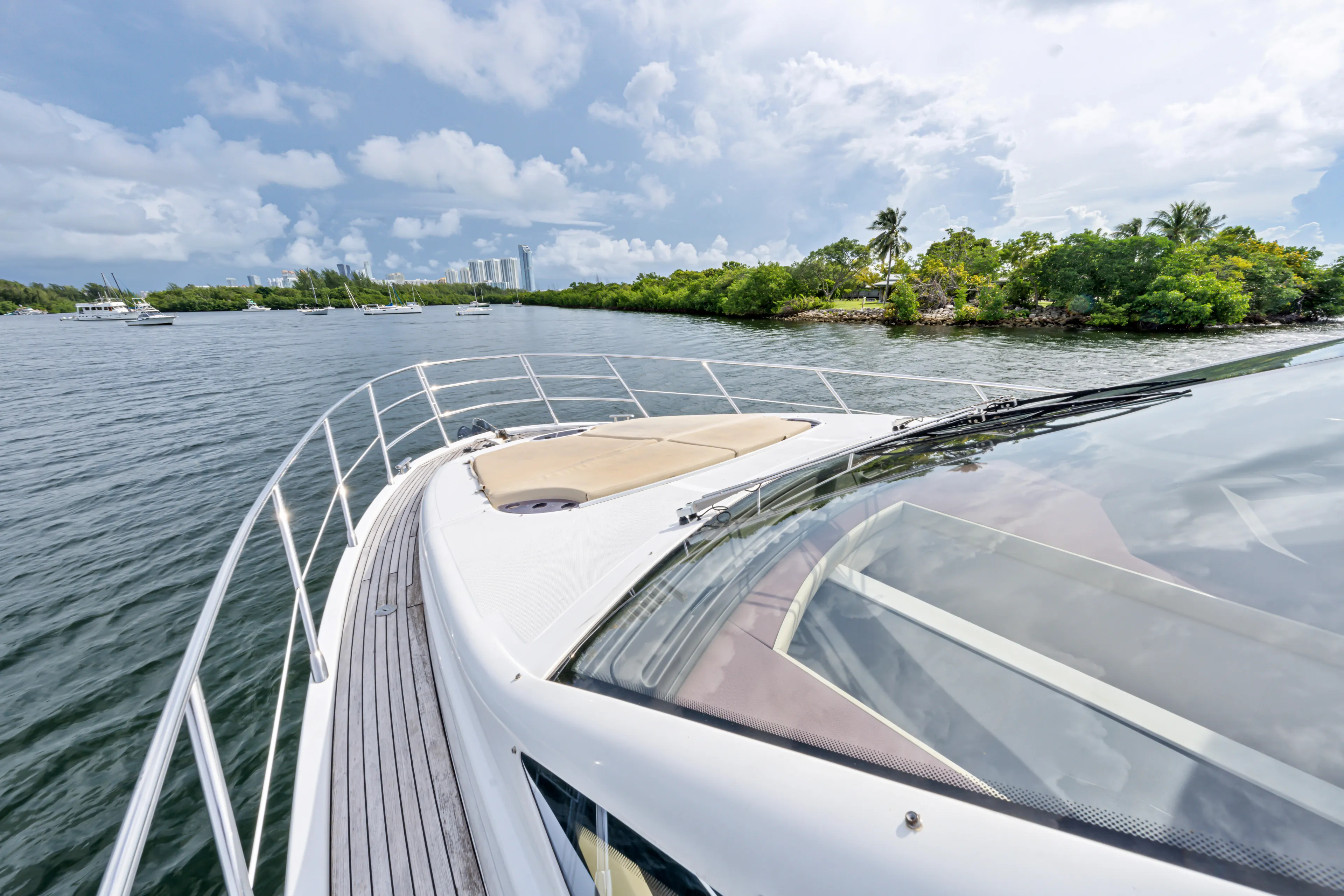  Yacht Photos Pics Azimut 54 Flybridge 2016 yacht cruising near lush green shoreline under cloudy sky.
