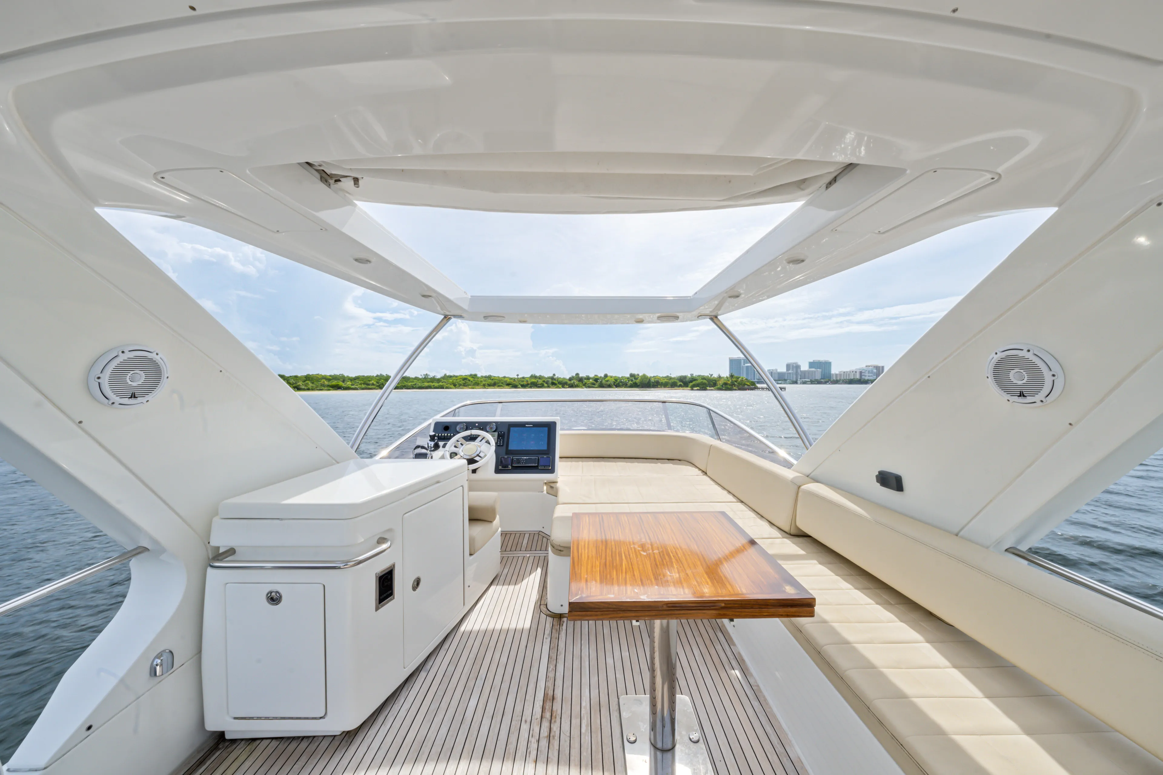  Yacht Photos Pics Luxurious 2016 Azimut 54 Flybridge yacht interior with seating and table, overlooking serene waters.