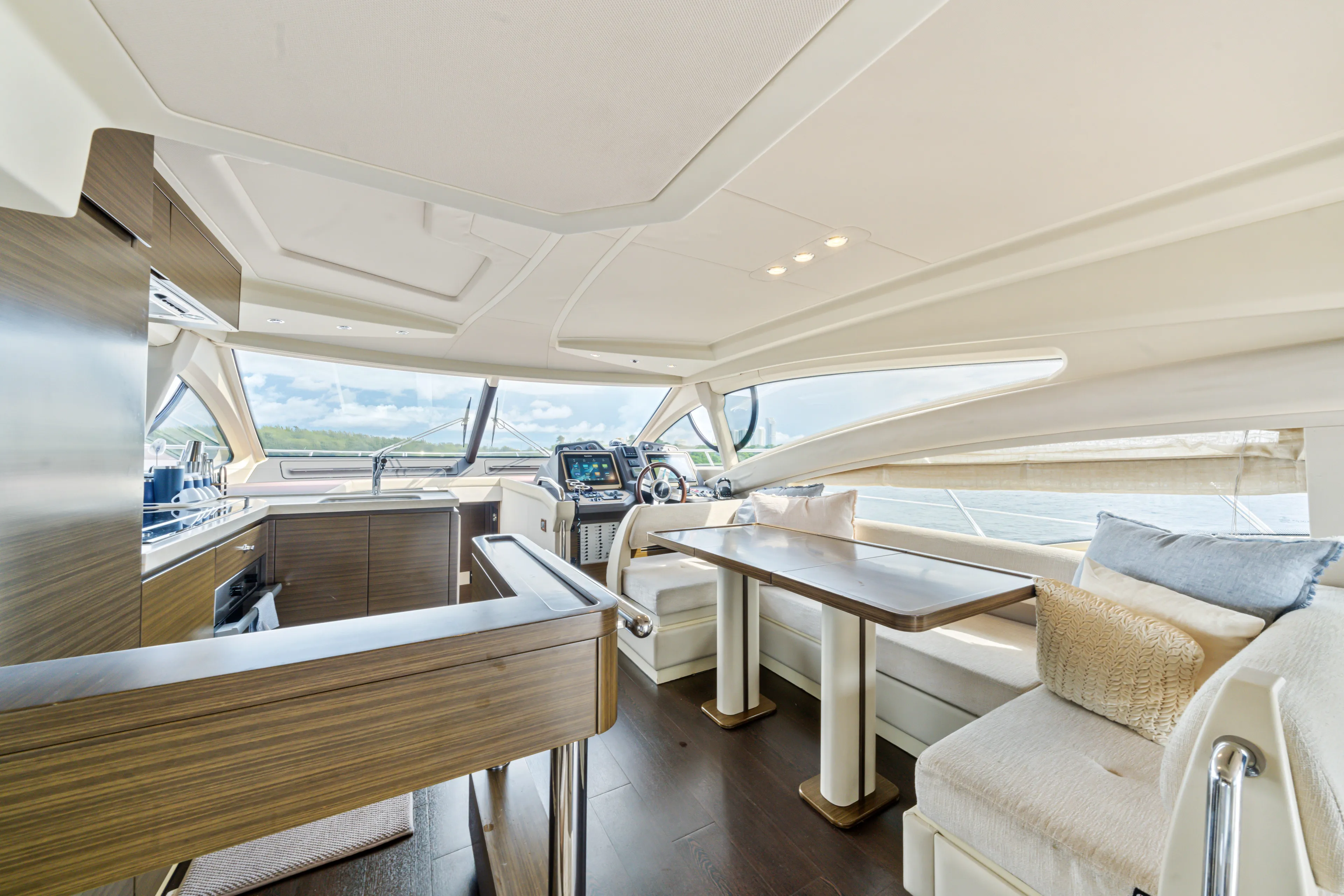  Yacht Photos Pics Luxurious interior of 2016 Azimut 54 Flybridge yacht with modern seating and panoramic windows.