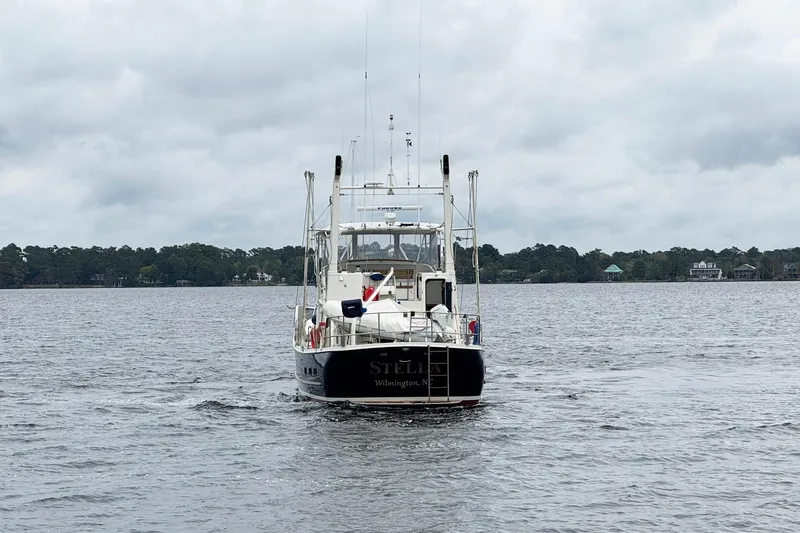  Yacht Photos Pics 1989 Seaton Trawler on a calm lake under cloudy skies.