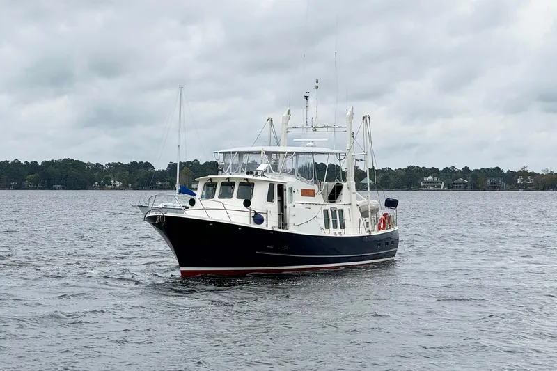  Yacht Photos Pics 1989 Seaton Trawler on calm waters under cloudy skies.