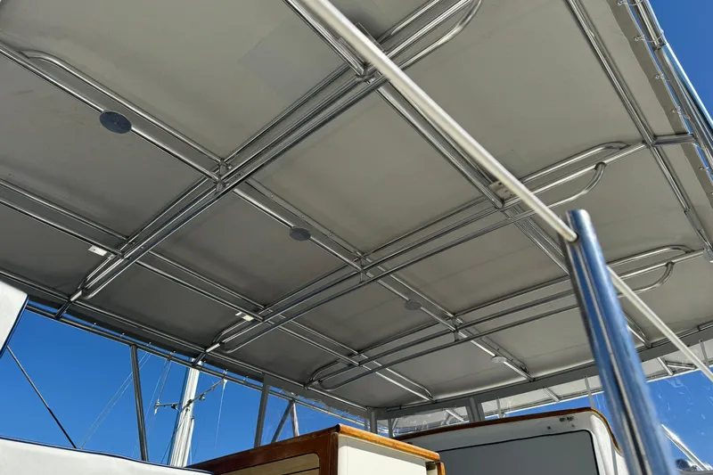  Yacht Photos Pics 1989 Seaton Trawler canopy with metal framework under clear blue sky.