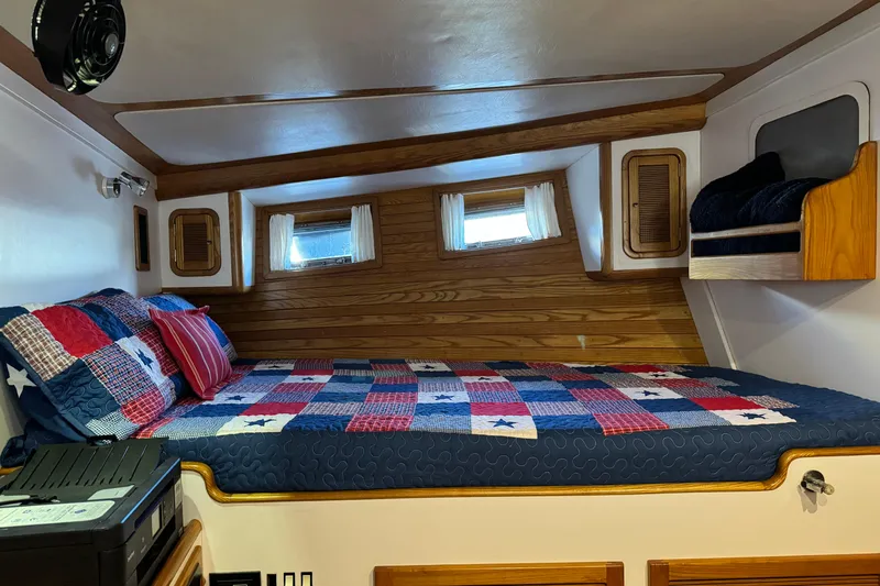  Yacht Photos Pics Cozy cabin interior of 1989 Seaton Trawler with colorful quilted bedding.