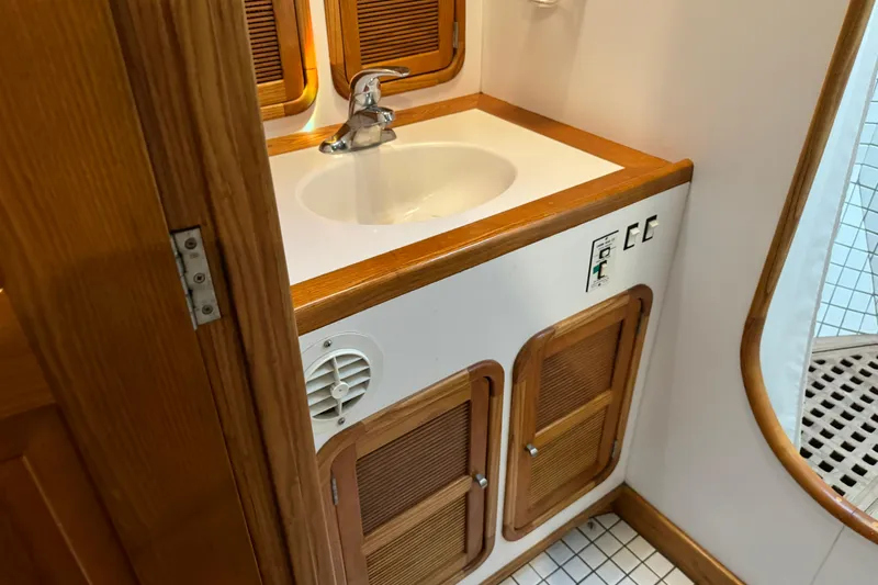  Yacht Photos Pics 1989 Seaton Trawler bathroom with wooden cabinetry and white sink.