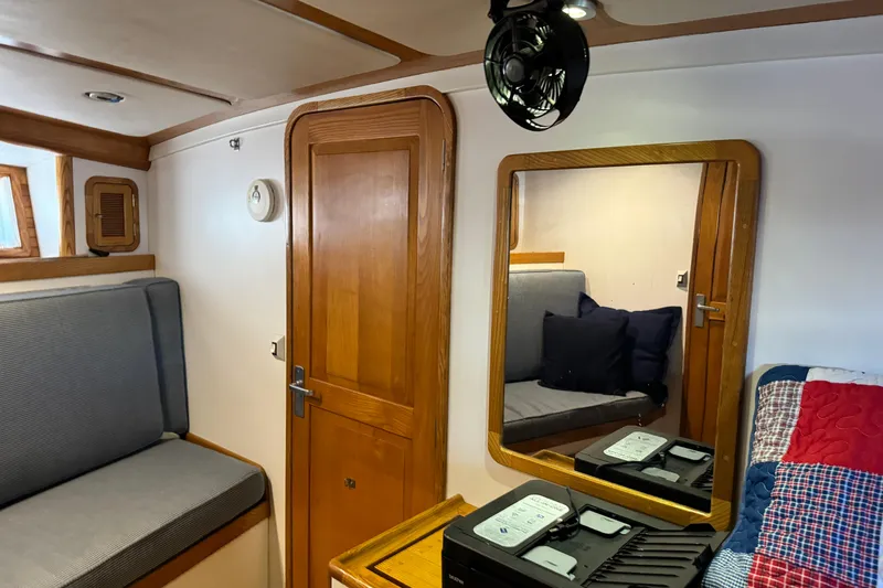  Yacht Photos Pics 1989 Seaton Trawler interior with wooden door, mirror, and seating area.