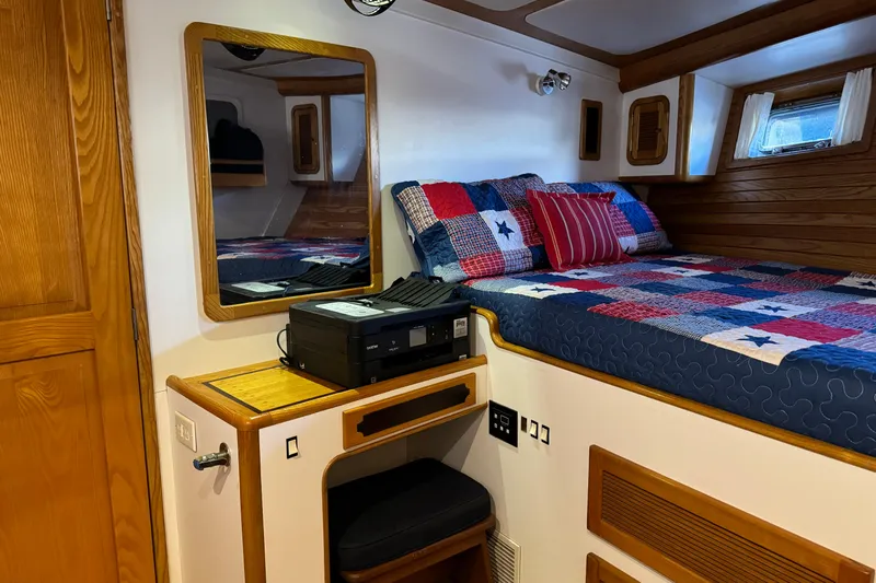  Yacht Photos Pics Cozy cabin interior of 1989 Seaton Trawler with bed, mirror, and printer.