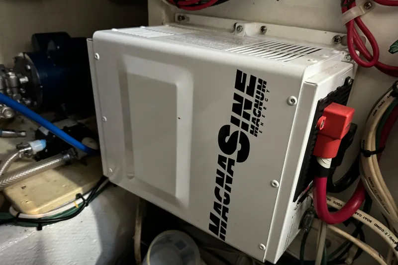  Yacht Photos Pics Magnum Energy inverter in 1989 Seaton Trawler engine room, surrounded by cables and equipment.