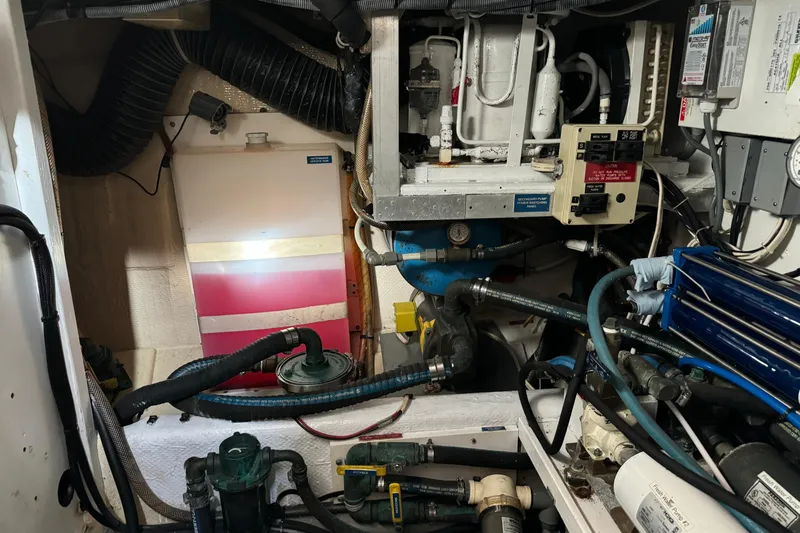  Yacht Photos Pics Engine room of a 1989 Seaton Trawler with various mechanical components and hoses.