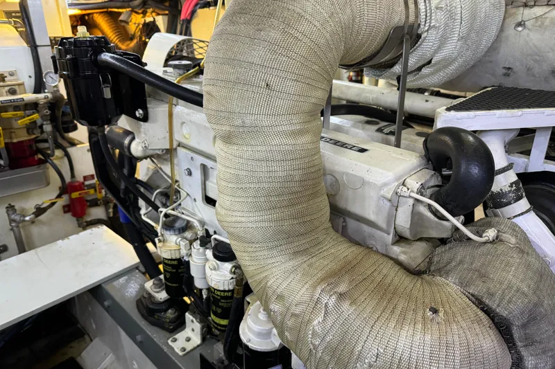  Yacht Photos Pics Engine room of a 1989 Seaton Trawler, showcasing wrapped exhaust components and mechanical details.