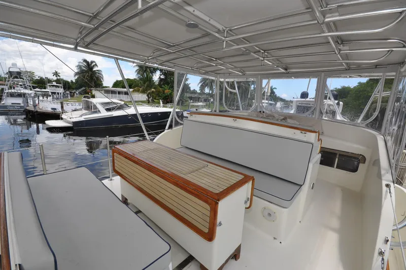  Yacht Photos Pics 1989 Seaton Trawler interior with seating, docked at marina, surrounded by other boats.