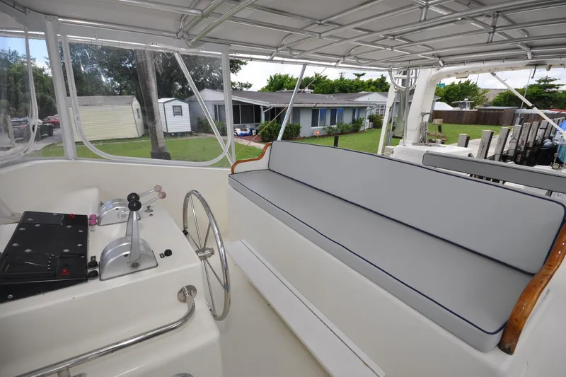  Yacht Photos Pics 1989 Seaton Trawler interior with steering wheel and cushioned seating.