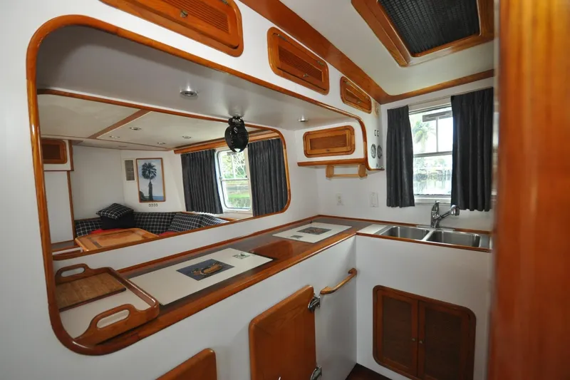  Yacht Photos Pics Interior of 1989 Seaton Trawler with wooden cabinetry and compact kitchen area.