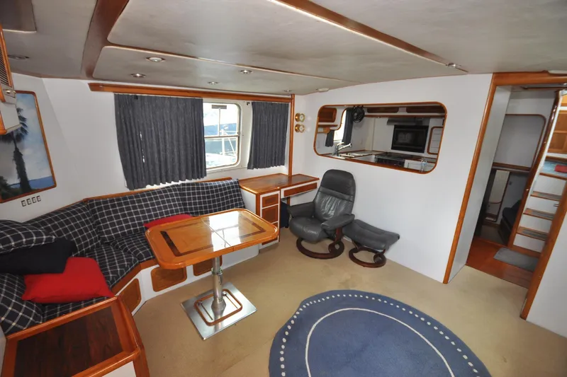  Yacht Photos Pics Interior of 1989 Seaton Trawler with cozy seating, table, and modern amenities.