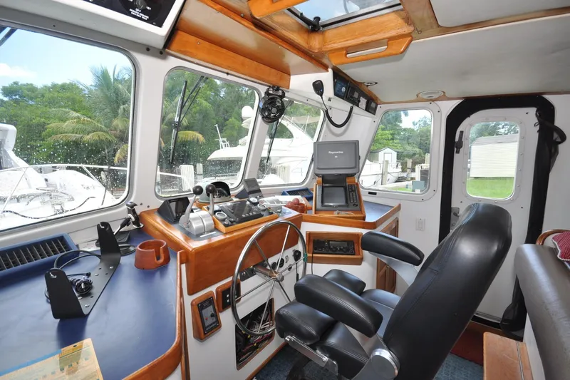  Yacht Photos Pics 1989 Seaton Trawler helm with navigation equipment, steering wheel, and comfortable seating.