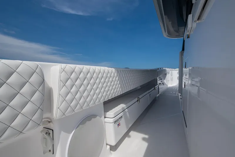  Yacht Photos Pics 2025 HCB 48 Campeon boat interior with quilted seating and sleek white design under blue sky.