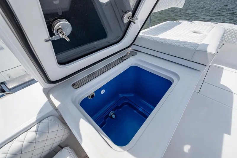  Yacht Photos Pics HCB 48 Campeon 2025 boat with open storage compartment, featuring quilted seating.