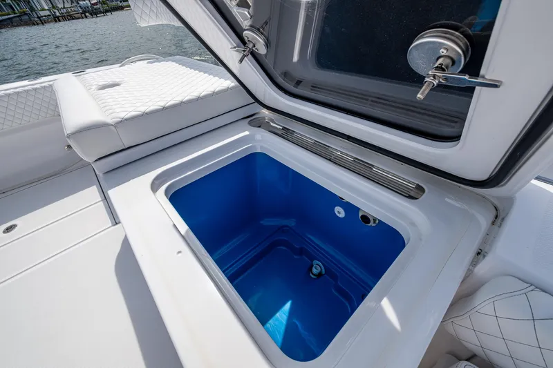  Yacht Photos Pics Open storage compartment on 2025 HCB 48 Campeon boat, featuring blue interior.