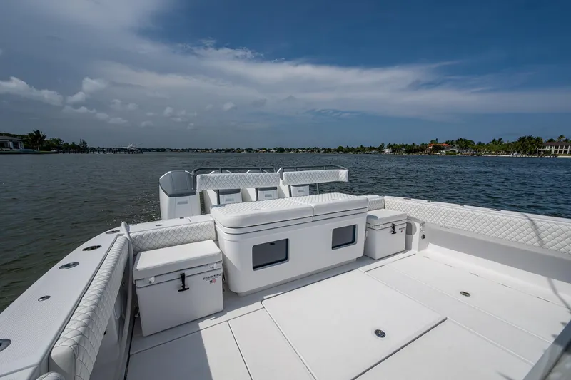  Yacht Photos Pics 2025 HCB 48 Campeon boat deck with seating, overlooking calm waters and distant shoreline.