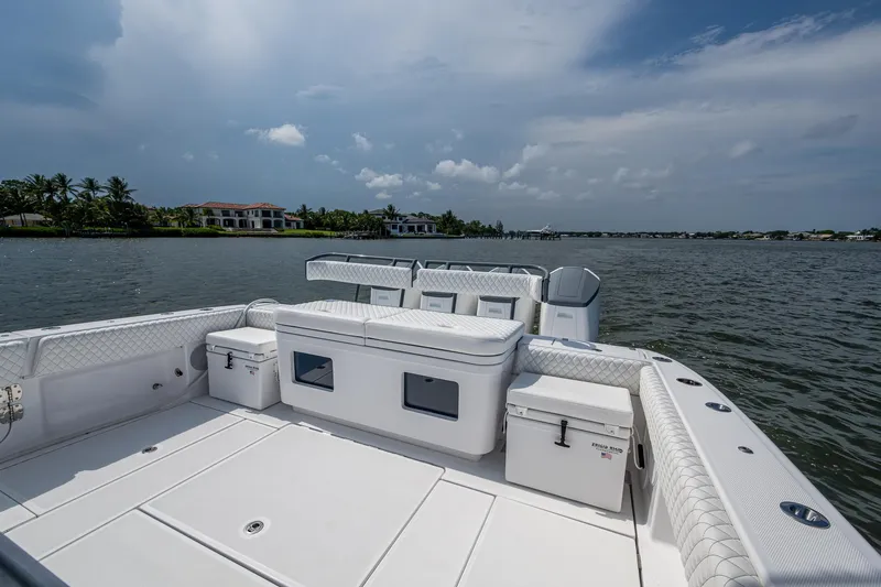  Yacht Photos Pics 2025 HCB 48 Campeon boat deck with seating, overlooking calm waters and distant shoreline.
