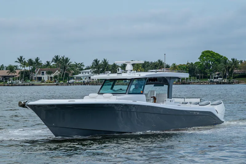  Yacht Photos Pics 2025 HCB 48 Campeon boat cruising on a calm waterway.