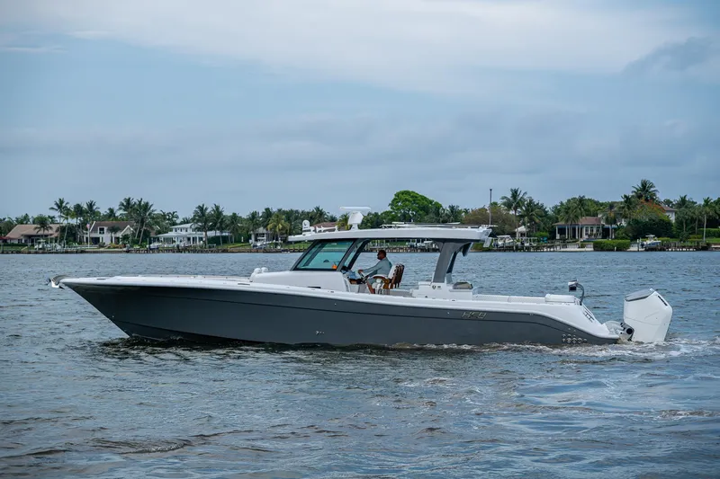  Yacht Photos Pics 2025 HCB 48 Campeon boat cruising on a calm waterway.