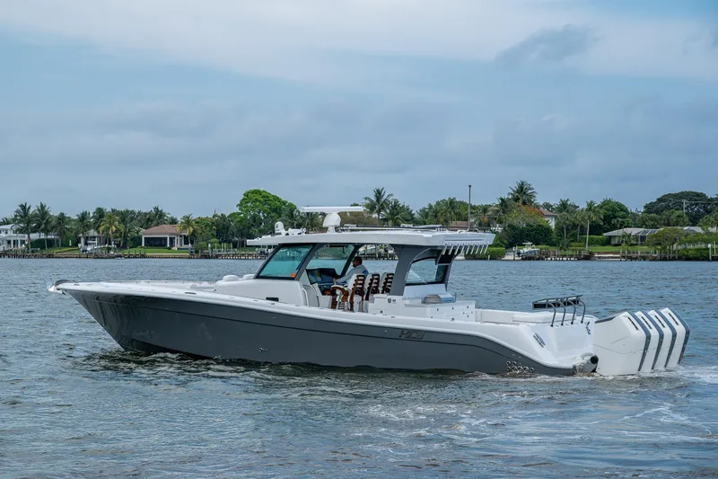  Yacht Photos Pics 2025 HCB 48 Campeon boat cruising on a calm waterway with a scenic backdrop.