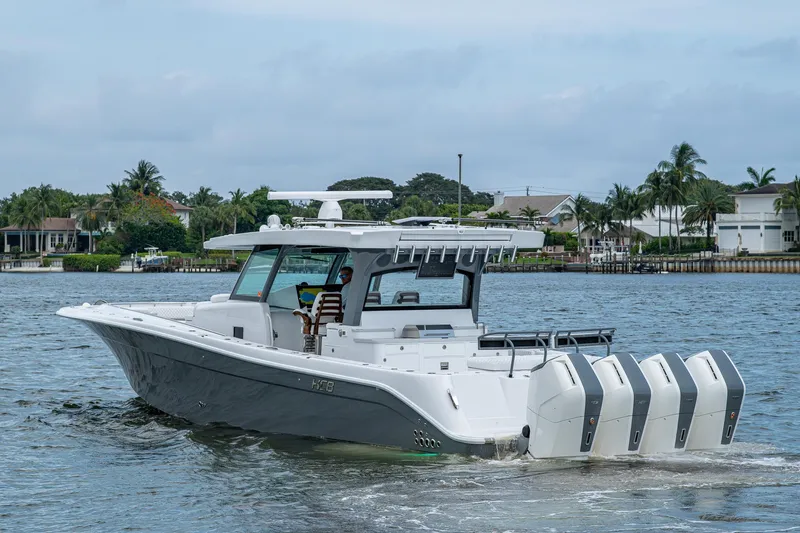  Yacht Photos Pics 2025 HCB 48 Campeon boat cruising on a scenic waterway.