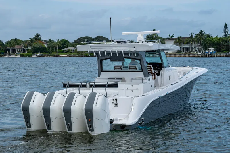  Yacht Photos Pics 2025 HCB 48 Campeon boat with four engines on a calm waterway.