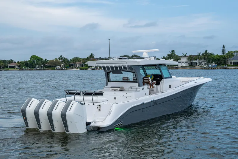  Yacht Photos Pics 2025 HCB 48 Campeon boat with four engines on a calm waterway.
