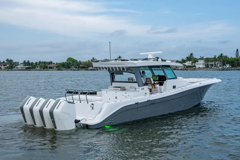  Yacht Photos Pics 2025 HCB 48 Campeon boat with multiple engines on a calm waterway.