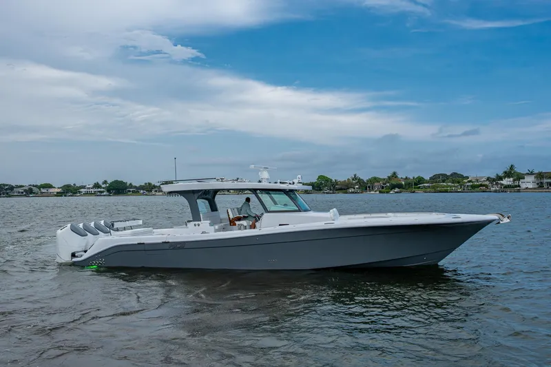  Yacht Photos Pics 2025 HCB 48 Campeon boat on calm water under a partly cloudy sky.