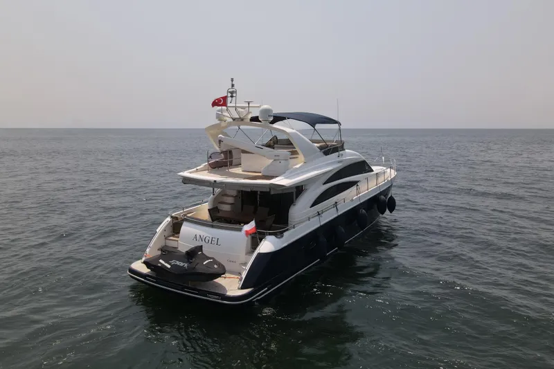  Yacht Photos Pics 2008 Princess 67 Flybridge yacht on open water, rear view.