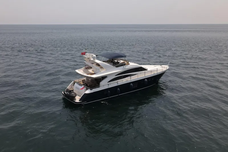  Yacht Photos Pics 2008 Princess 67 Flybridge yacht cruising on open sea under clear sky.